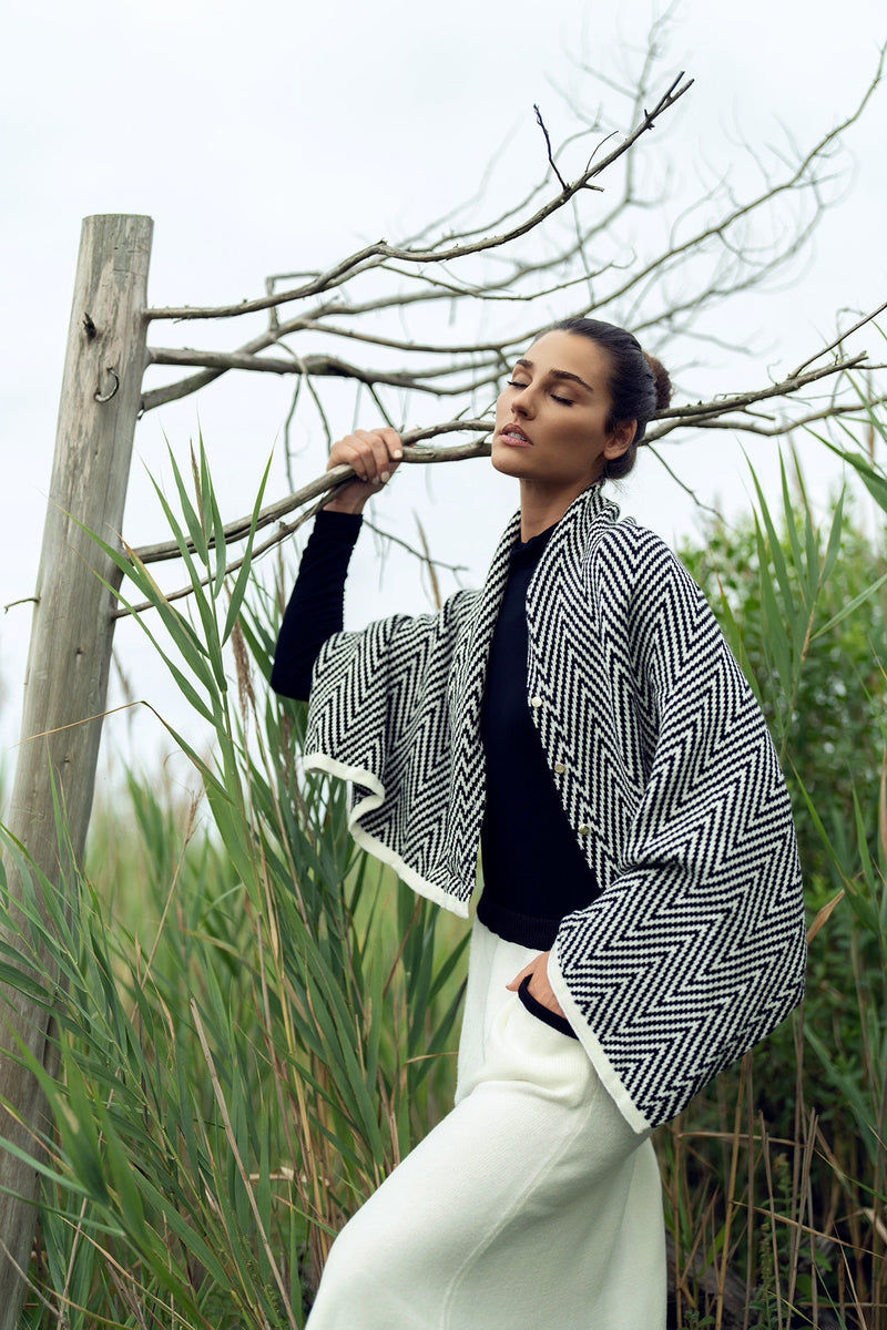 Soft knit shawl by profile-nyc featuring a cozy, textured design, perfect for layering and adding warmth to your outfit.
