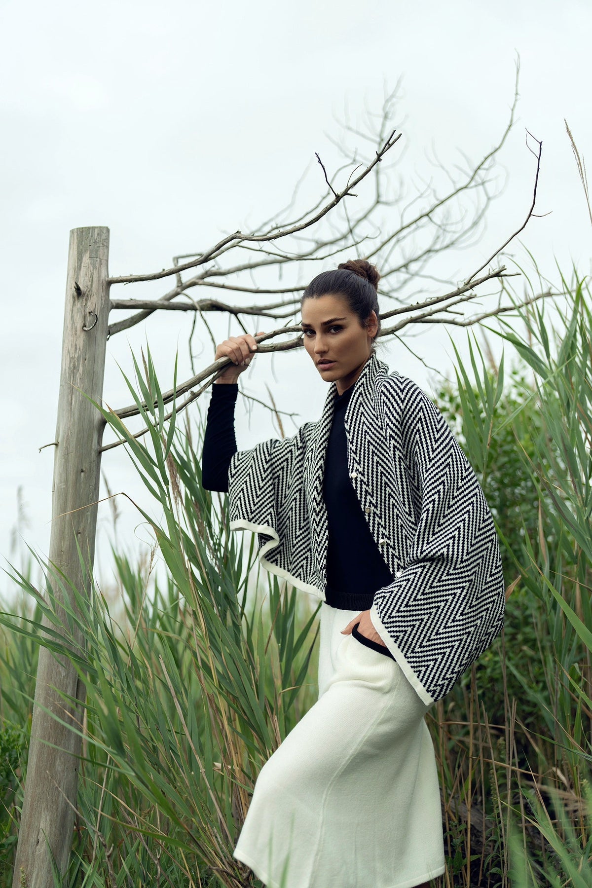 Soft knit shawl by Profile NYC draped over a neutral background, showcasing its cozy texture and versatile style.