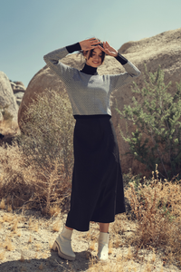 Profile NYC wool seam skirt featuring a tailored fit, with visible seam details and a classic A-line silhouette.