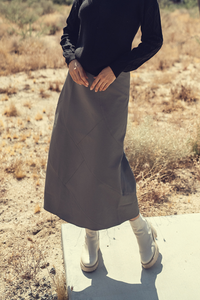 Profile NYC wool seam skirt featuring a tailored design, in a neutral color, shown on a model with a mid-length fit.