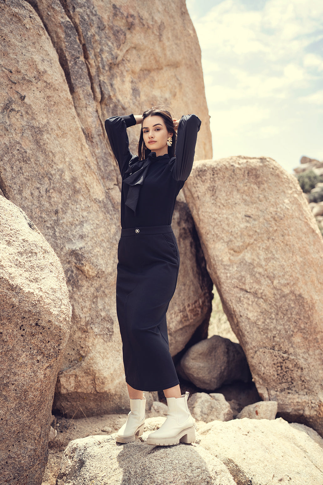 Black straight stretch skirt by Profile NYC, showing smooth fabric and fitted silhouette on a mannequin.