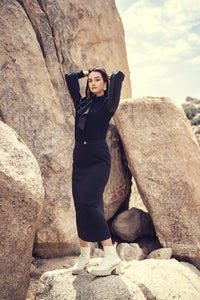 Black straight stretch skirt by Profile NYC, showing smooth fabric and fitted silhouette on a mannequin.