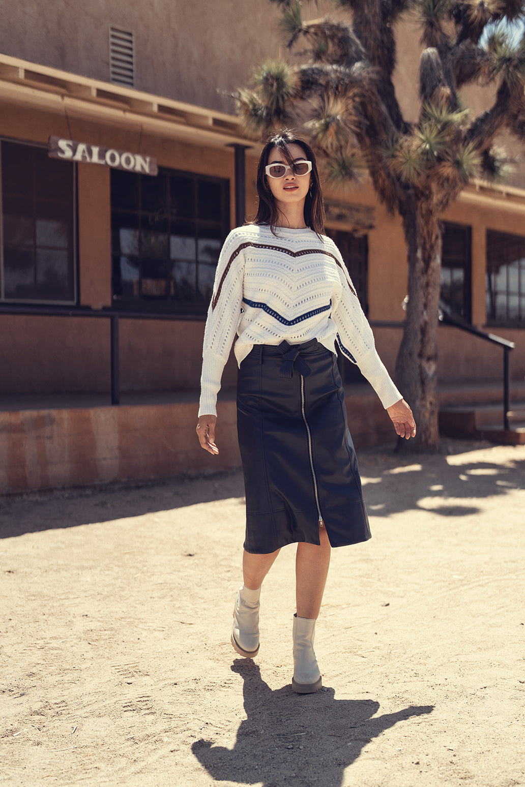 Black leather zipper skirt from Profile NYC featuring a fitted design and front zipper closure, styled on a mannequin.