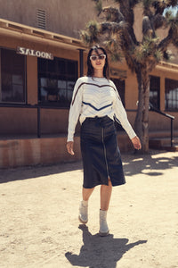 Black leather zipper skirt from Profile NYC featuring a fitted design and front zipper closure, styled on a mannequin.