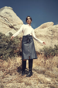 Black leather zipper skirt from Profile NYC featuring a fitted design and front zipper detail.