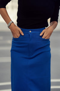 Colorful stretch denim skirt by Profile NYC, showing a close-up of the vibrant multicolored fabric and fitted waist.