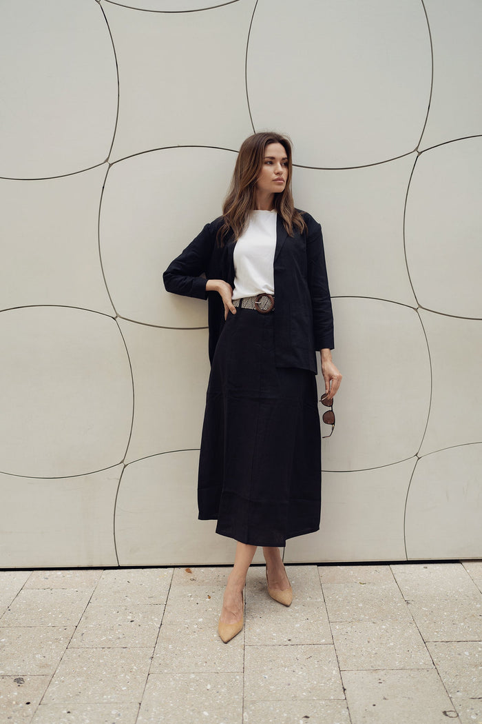 Black Lina belted skirt by Profile NYC, showcasing a stylish high-waist design with a matching belt and smooth fabric.