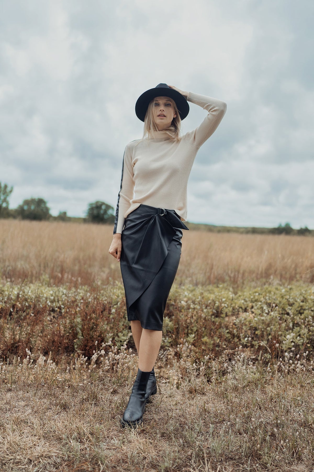 Black straight leather skirt with front buckle detail, stylish and fitted, by Profile NYC.
