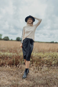 Black straight leather skirt with front buckle detail, stylish and fitted, by Profile NYC.
