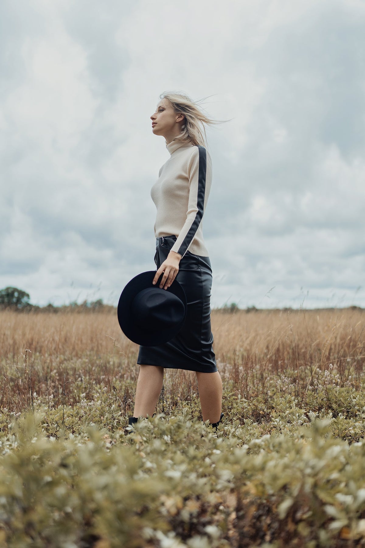 Leather skirt with buckle detail from Profile NYC, featuring a sleek straight cut and stylish buckle accents.