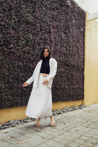 Ivory Lina belted skirt by Profile NYC, featuring a stylish fit and waist belt, displayed on a neutral background.
