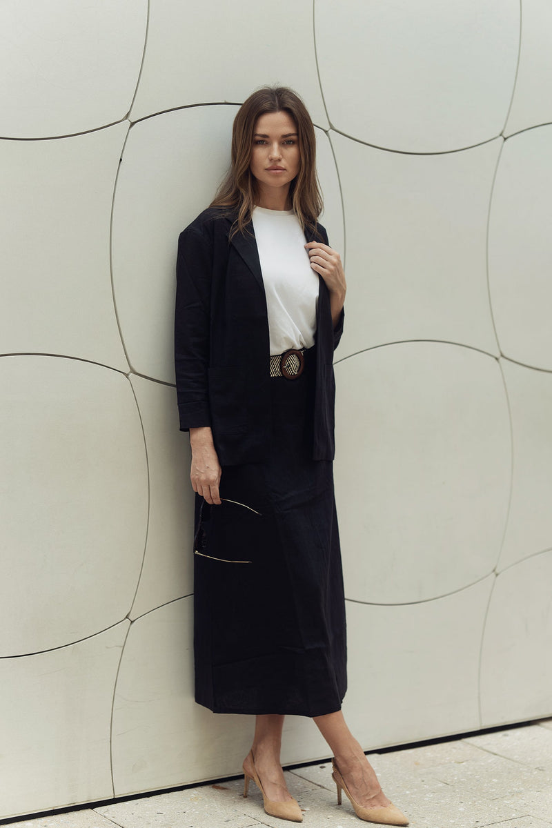 Ivory Lina belted skirt by profile-nyc, shown flat on a white background with a tie belt and clean, tailored design.