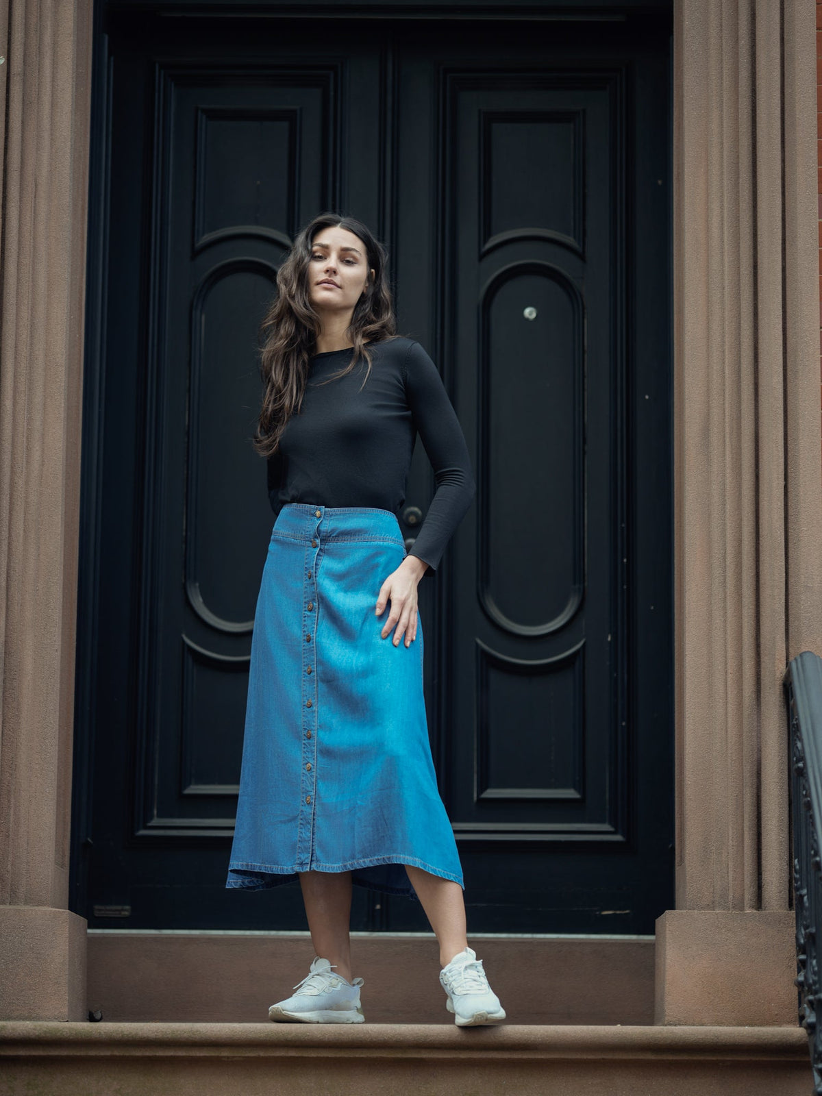 Soft denim button skirt by Profile NYC, showing a stylish A-line design with front buttons and a casual, versatile look.