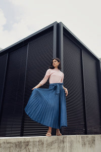 TENCEL drop waist pleated skirt by profile-nyc, shown in soft fabric with a flowing, feminine design and pleated detailing.