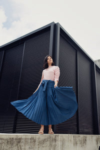 TENCEL drop waist pleated skirt by profile-nyc, featuring a flowy design and a relaxed fit, shown in a natural fabric finish.