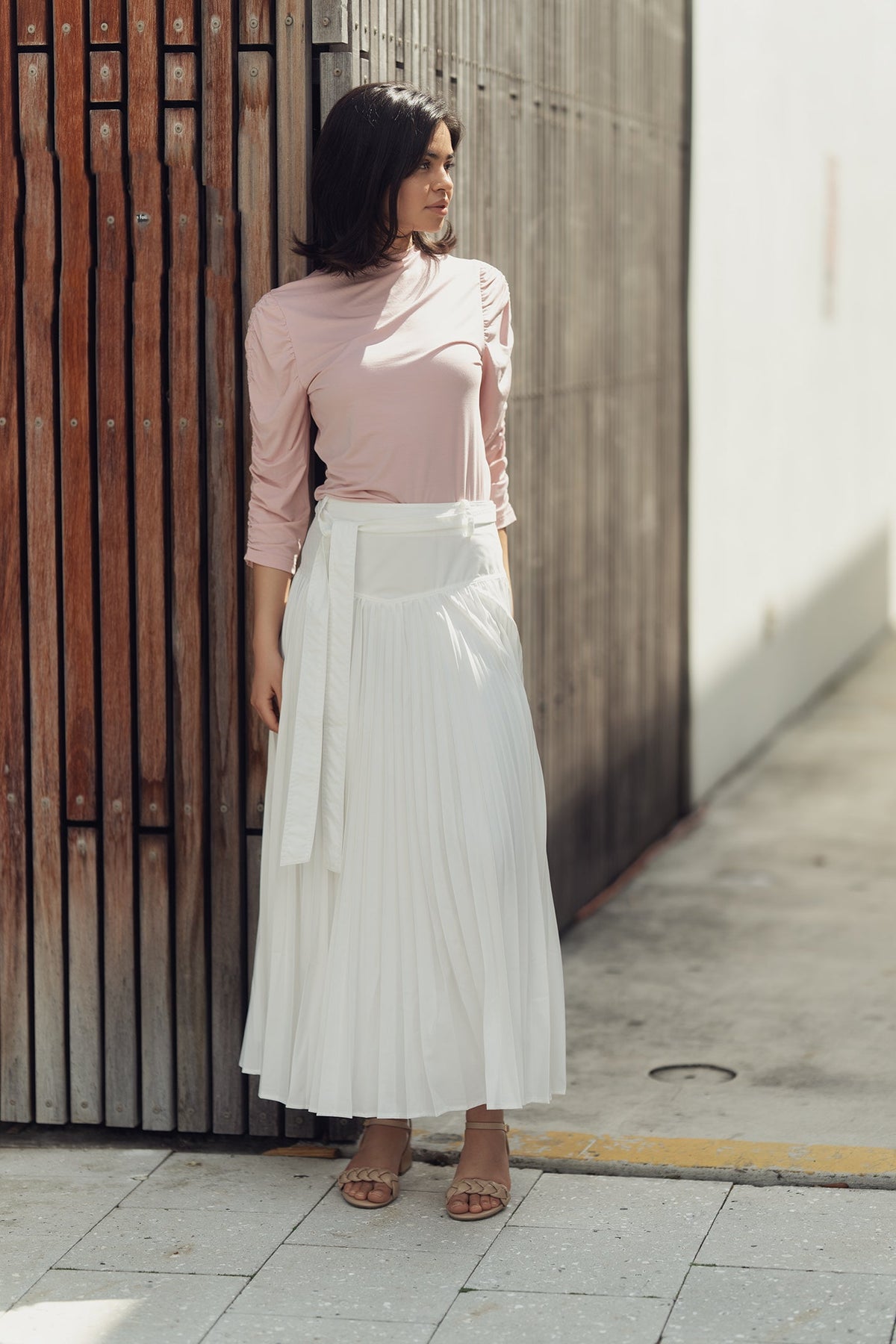 Profile NYC drop waist pleated skirt shown on a model, featuring a flowy silhouette and stylish pleats for a chic, modern look.