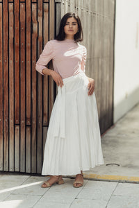 Pleated drop waist skirt by Profile NYC displayed on a model, featuring a flowy design and feminine silhouette.