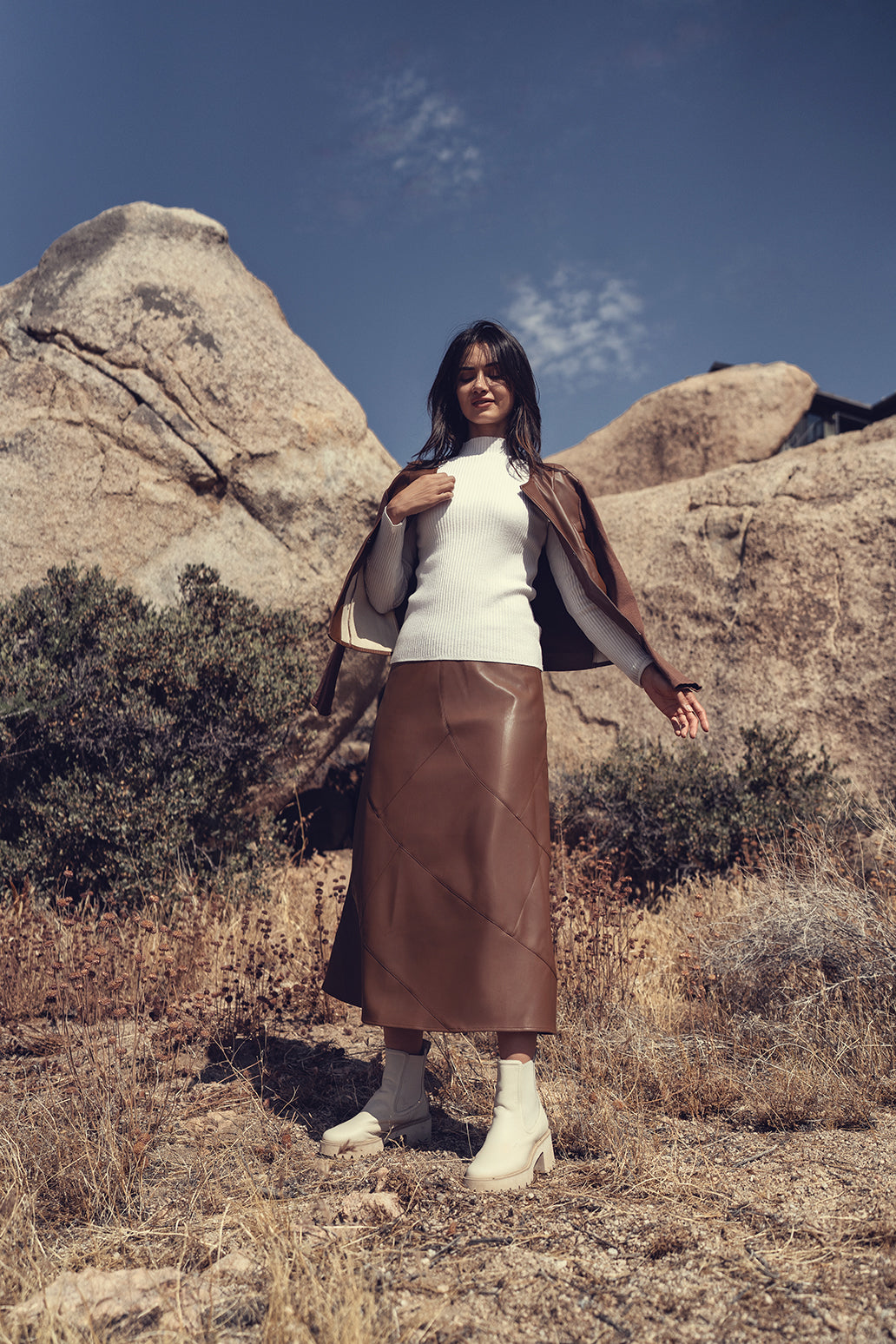Black leather seam skirt from Profile NYC, featuring a fitted design and seam details, displayed on a neutral background.
