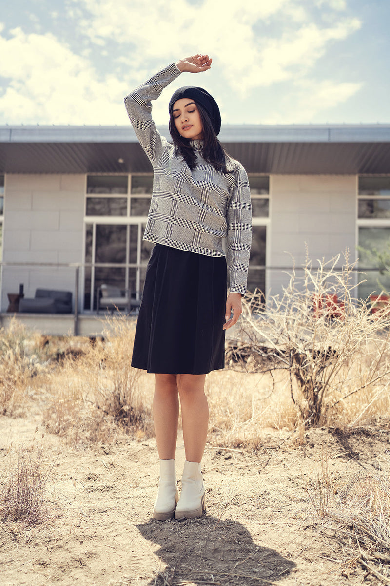 Close-up of a cozy knit turtleneck sweater from Profile NYC, showing textured fabric and classic design.