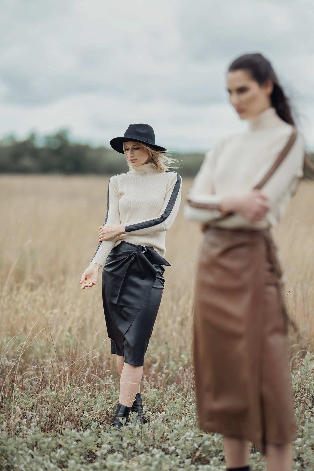 Navy turtleneck sweater with leather shoulder detail from Profile NYC, featuring a cozy fit and stylish design.