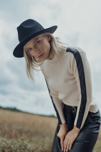 Navy turtleneck sweater with leather shoulder detail from Profile NYC, featuring a cozy knit and stylish leather accents.