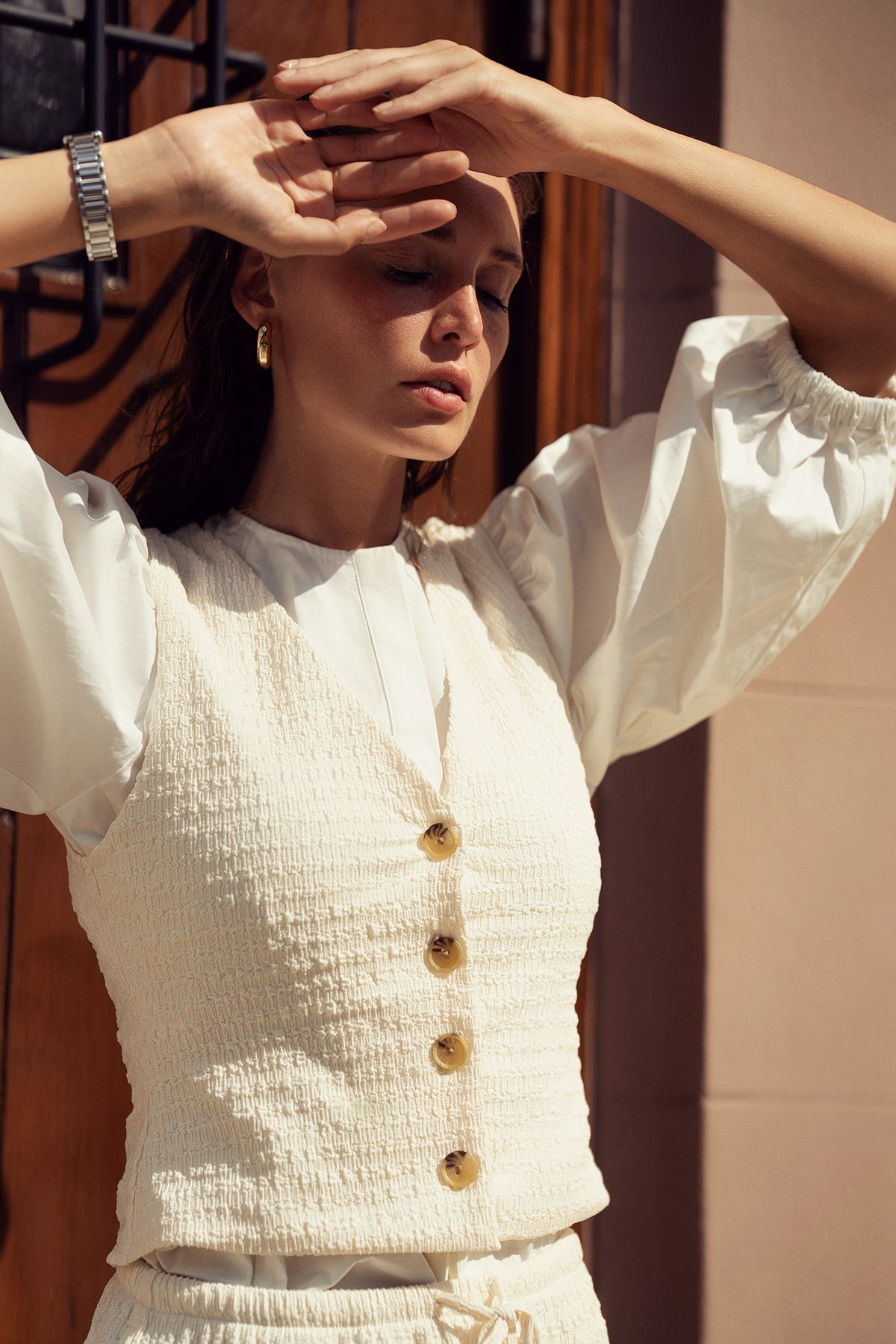 Profile NYC crinkle cream vest top with textured fabric and sleeveless design, styled for casual or layered looks.