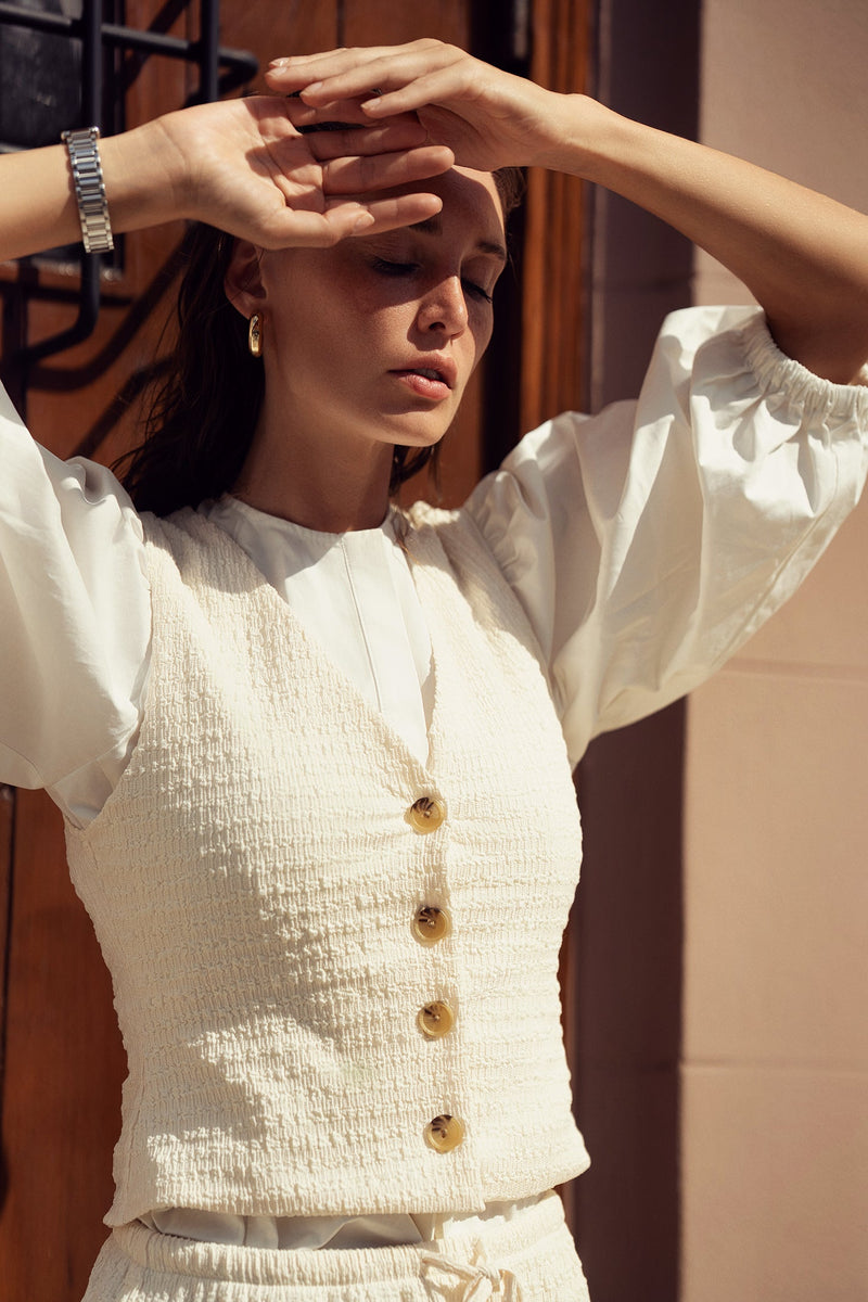 Profile NYC crinkle cream vest top with textured fabric and sleeveless design, styled for casual or layered looks.