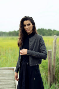 Close-up of a wool and leather jacket from profile-nyc, showcasing the textured wool and smooth leather details.