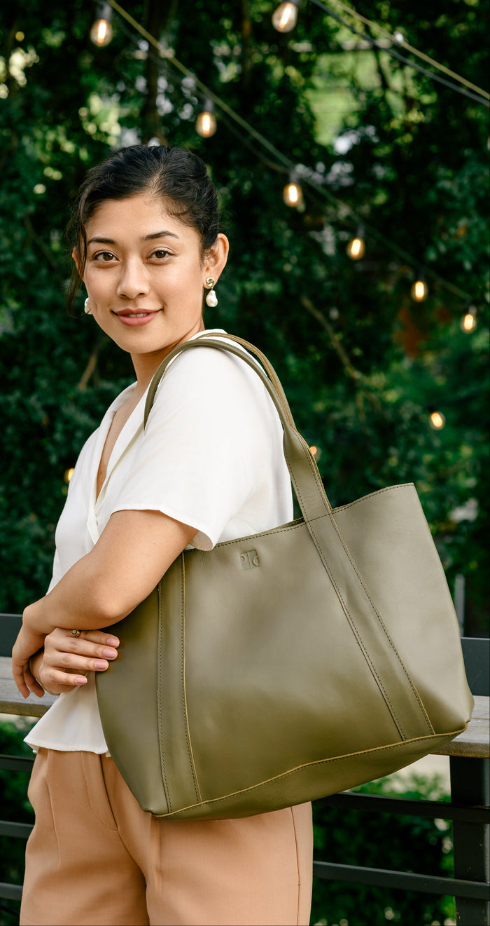 Medium Purse & Clutch crossbody tote bag with adjustable strap and spacious interior, shown in a natural setting.