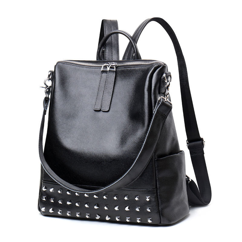 Black genuine leather women's backpack with rivet accents and Korean fashion style by Rirati, featuring a spacious design and sturdy straps.