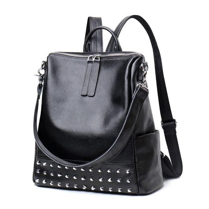 Black genuine leather women's backpack with rivet accents and Korean fashion style by Rirati, featuring a spacious design and sturdy straps.