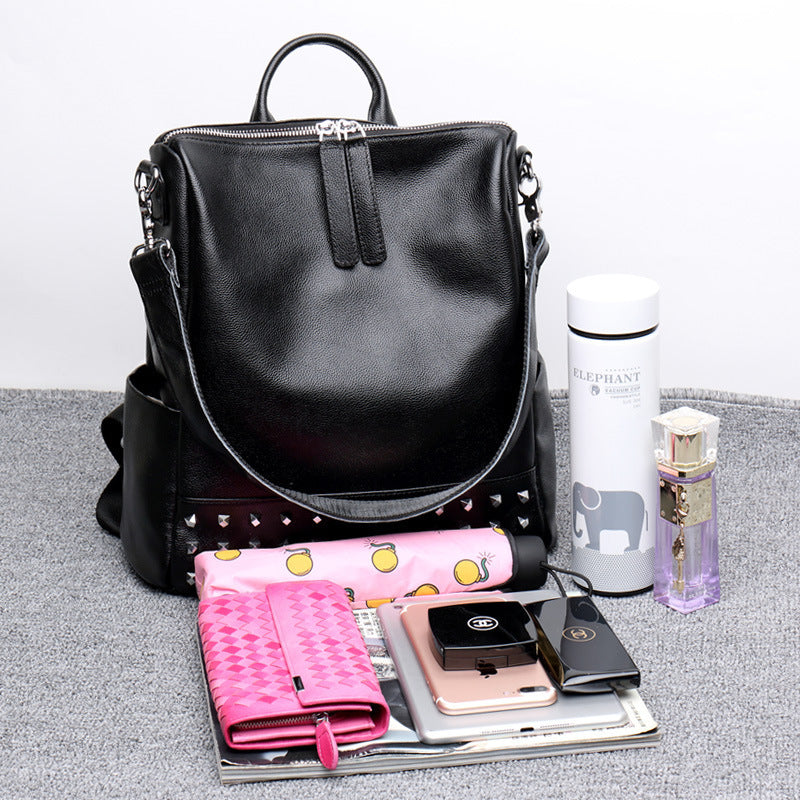 Black women's Rirati leather backpack with rivets, stylish Korean fashion backpack featuring a spacious design and personality details.