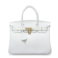 White women's leather handbag by Rirati featuring a portable, strapless design made from genuine cowhide leather.
