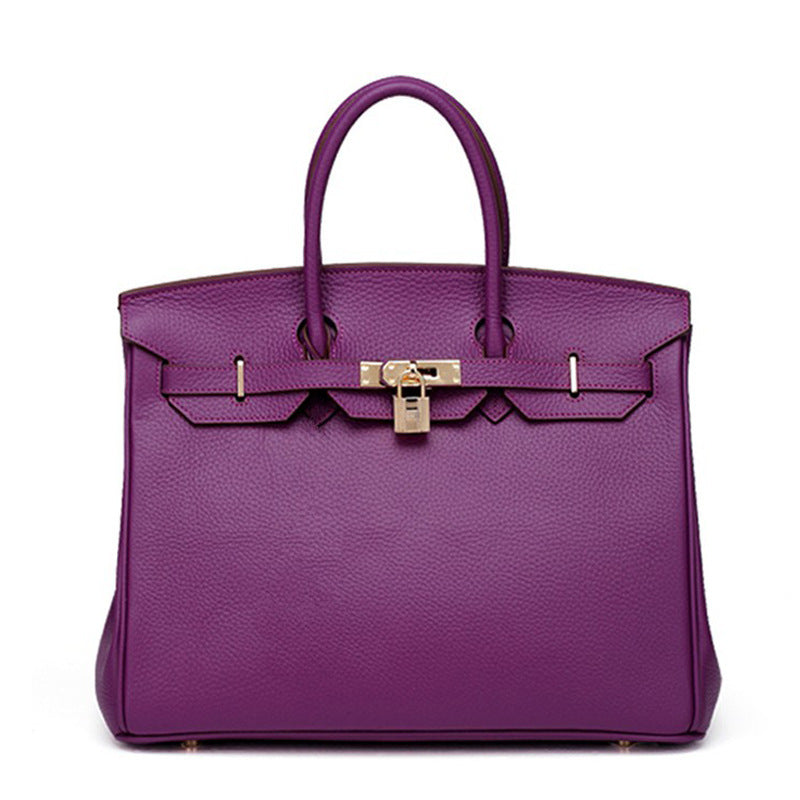 White Rirati women's leather handbag with 35cm strap, made from genuine cowhide, featuring a sleek, portable design.