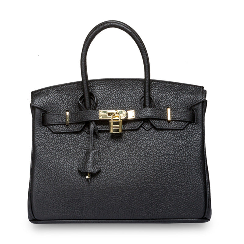 White women's leather handbag by Rirati, made from genuine cowhide, featuring a portable, strapless design with a sleek look.