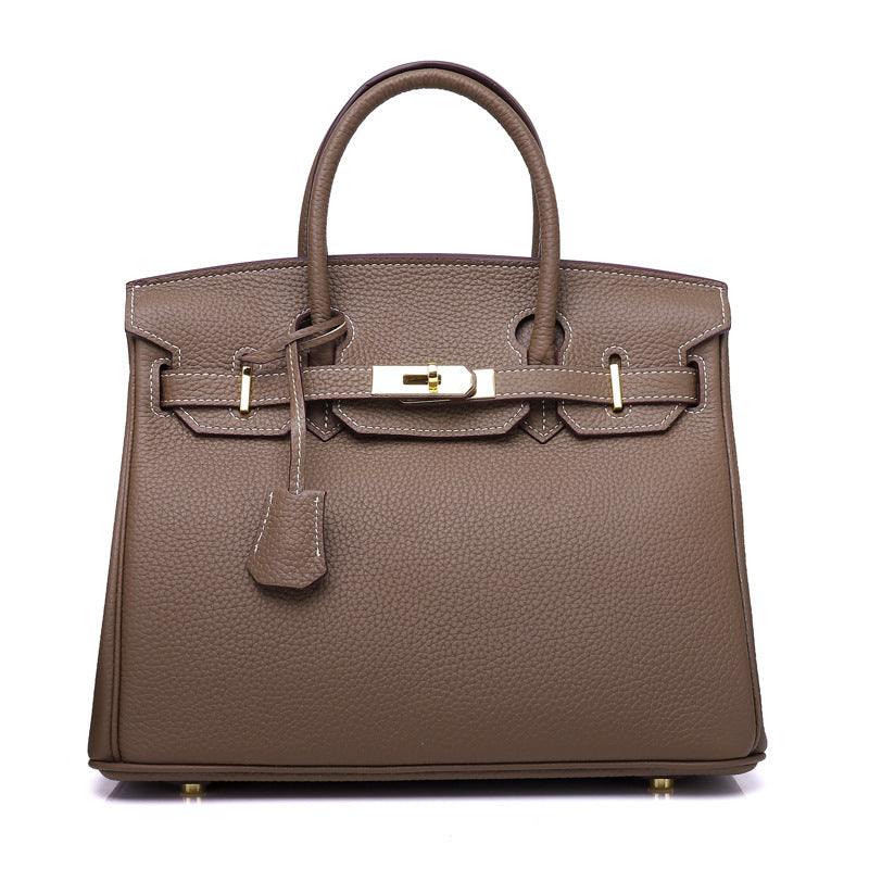 White women's handbag by Rirati featuring genuine cowhide leather, portable design, and 35cm strapless style.