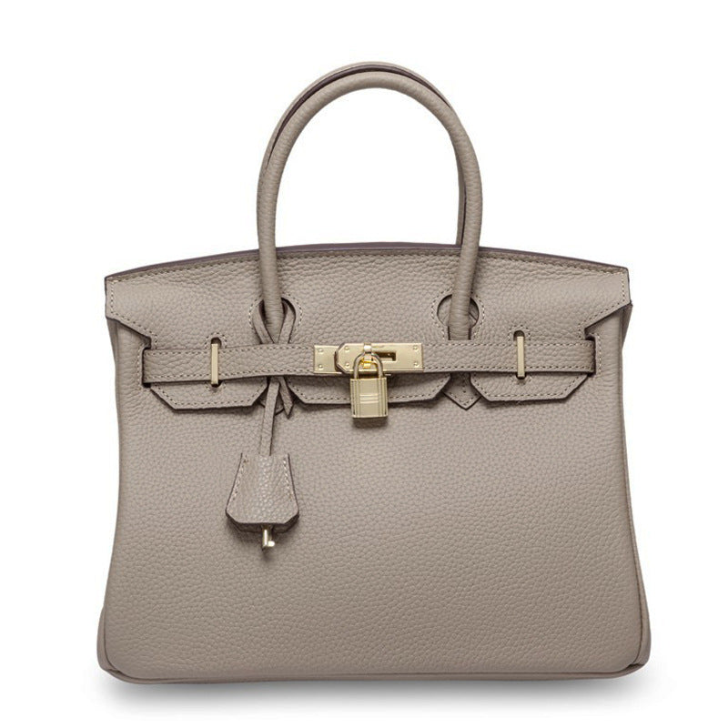 White women's Rirati handbag made of genuine cowhide leather with a portable, strapless design and spacious interior.