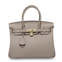 White women's Rirati handbag made of genuine cowhide leather with a portable, strapless design and spacious interior.