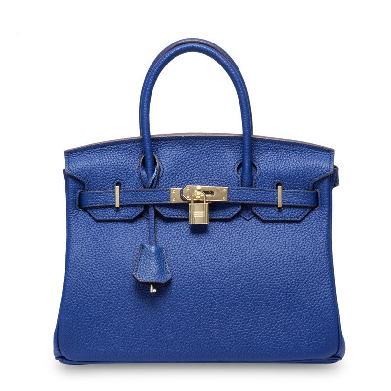 White Rirati women's handbag made from genuine cowhide leather, featuring a portable design and 35cm strapless style.