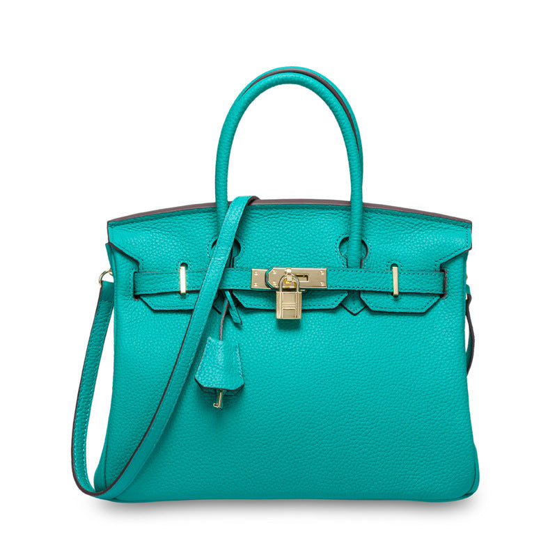 White women's leather handbag by Rirati, made from genuine cowhide, with a portable, strapless design and spacious interior.