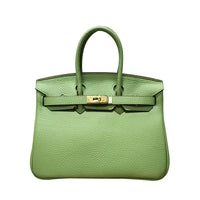 White women's leather handbag by Rirati, made from genuine cowhide, featuring a portable design and a 35cm strap.