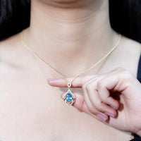 Elegant Swiss Blue Topaz pendant with lab diamond, designed wedding necklace by Rosec Jewels, showcasing intricate craftsmanship.