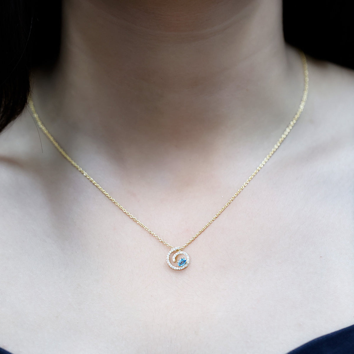 Genuine sky blue topaz and diamond swirl pendant necklace with silver chain from Rosec Jewels, showcasing sparkling gemstones and elegant design.