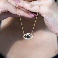Natural 1.6 carat black diamond evil eye pendant in yellow gold plated silver, featuring a detailed evil eye design.