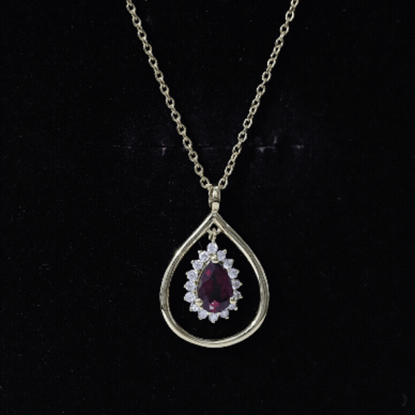 Rhodolite garnet and diamond teardrop pendant necklace with silver chain from Rosec Jewels, showcasing a vibrant red gemstone and sparkling accents.