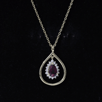 Rhodolite garnet and diamond teardrop pendant necklace with silver chain from Rosec Jewels, showcasing a vibrant red gemstone and sparkling accents.