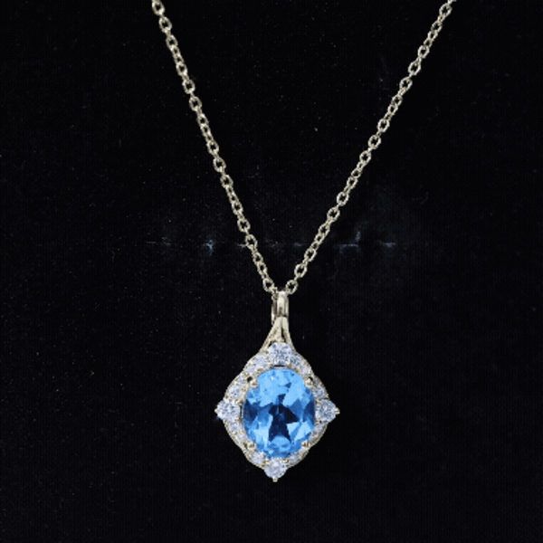 Vintage Sky Blue Topaz diamond halo pendant necklace by Rosec Jewels, showcasing a sky blue topaz gemstone surrounded by a diamond halo.
