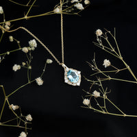 Vintage sky blue topaz pendant with diamond halo necklace from Rosec Jewels, showcasing a delicate pendant on a fine chain.