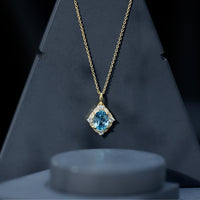 Vintage sky blue topaz pendant with diamond halo necklace by Rosec Jewels, showcasing a sparkling gemstone and elegant design.