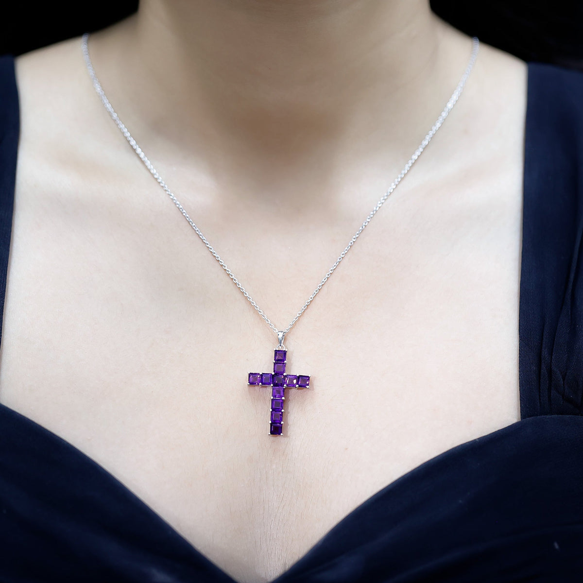 Princess cut amethyst cross pendant necklace with silver chain from Rosec Jewels, featuring a sparkling purple gemstone and elegant design.